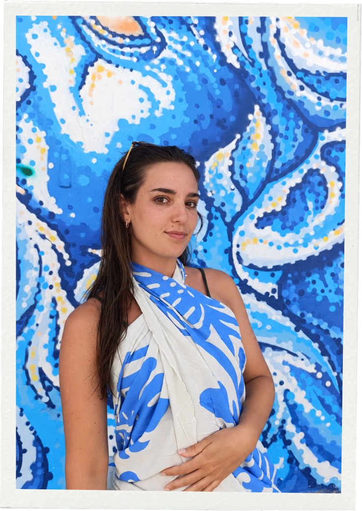 Sofía Prada standing in front of a vivid blue artwork